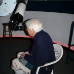 An observer looking through the Little Thompson Observatory's 6-inch Astro-Physics refractor.